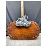 Wooden cutting board with metal pitcher and fruit decoration