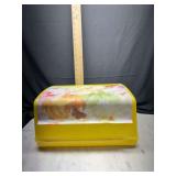 Yellow plastic bread box with floral pattern
