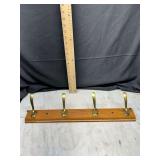 Wooden coat rack with 4 brass hooks