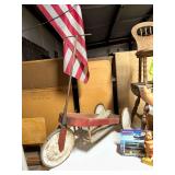 Handmade Wooden Three-Wheeled Scooter with T-Handlebar and Attached Flag