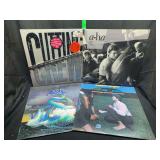 Lot of 4 12-Inch Vinyl Records Featuring Cutting Crew, A-Ha, Asia, and Robert Palmer
