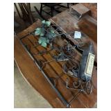 Metal wine rack with grape leaf decor