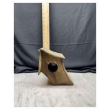 Rustic wooden birdhouse with angled design