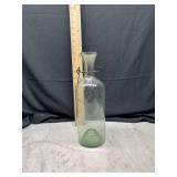 Green glass bottle with wire handle