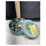 Round metal tin with assorted buttons
