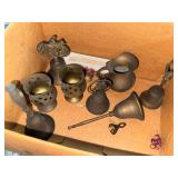 Brass bells, candle holders and cream pitcher