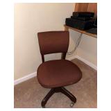 Brown upholstered office chair with casters