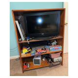 Wooden bookshelf with Sanyo television and electronics