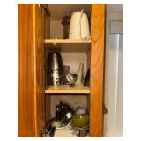 food processor, attachments, misc kitchen items in cabinet left of sink