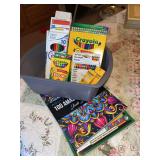 Crayola crayons colored pencils and coloring books in bin