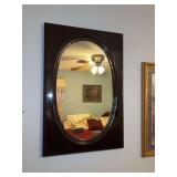 Dark wood framed oval wall mirror