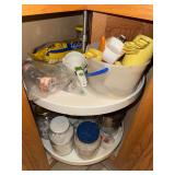 Vintage measuring spoons and cups and items in bottom cabinet corner cabinet