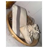 Basket with vintage nurse hat, baby shoes, ornament