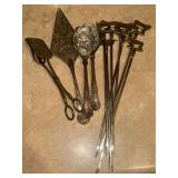 Vintage kebab skewers and ornate serving utensils