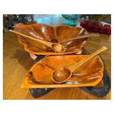 Vintage teak wood leaf shaped serving bowls on stands with wooden serving utensils