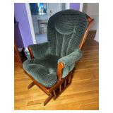 Glider rocking chair with green cushions