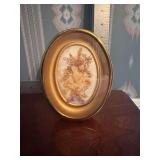 Vintage pressed dried flowers in miniature oval frame
