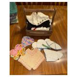 Crochet doll hats/clothes and ladies collars in wooden basket