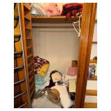 Contents of front bedroom closet-blankets, shoe rack, pillows