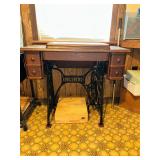 Antique singer sewing machine in oak and cast iron cabinet