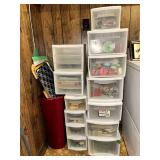 Group of storage containers full of ribbon, crafting supplies, cutting boards and misc