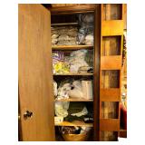 Closet of bed linens, fabric scraps and pillows