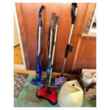 Group of stick vacuums and sweepers