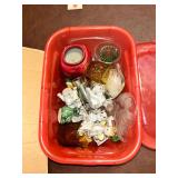 Kitschy figurines and knickknacks in red bin