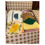 Box of linens- dish towels, hot pads, blender covers and more