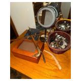 Basket of wrist watches, duck head shoe horn, photo box, magnifying mirror