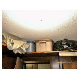 Storage containers and craft related items in craft room top shelf