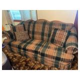 Plaid upholstered sofa with wood carved accent on top