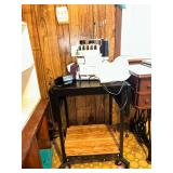 Singer Ultralock 14U32 series serger sewing machine on drop leaf cart