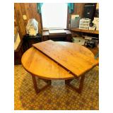 Round oak dining table with leaf and geometric style base