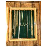 Shadow box full of chain necklaces