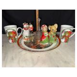 Christmas mugs and bells on Christmas plates