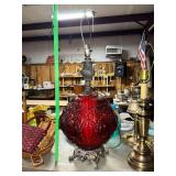 Hollywood regency style ruby red glass parlor lamp with ornate metal base