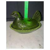 Modern small green plastic hen on nest pink