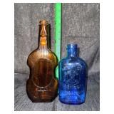 Vintage whiskey and milk of magnesia glass bottles