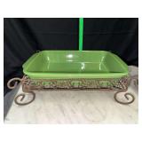 Green casserole dish in scroll work stand