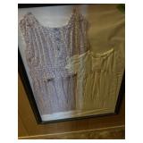 Framed old childrens clothes