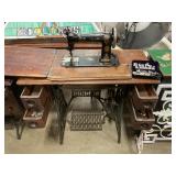 Antique Singer sewing machine in cabinet