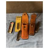 Assorted pocket knives and sheaths