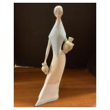 Porcelain woman holding jug statue