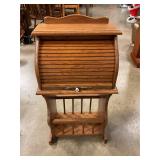 Magazine rack with roll top storage