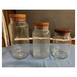 3 glass canisters w wood lids