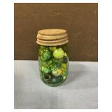 Small green mason jar of marbles