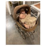 Antique dolls and wicker baby carriage