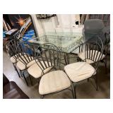 Glass top table with metal legs and six chairs