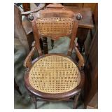 Antique walnut cane seat armchair
